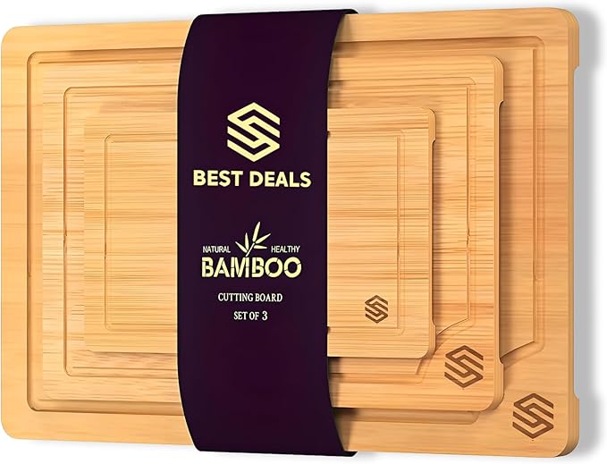 3-piece bamboo cutting board set showing three sizes with deep juice grooves and built-in handles on kitchen counter