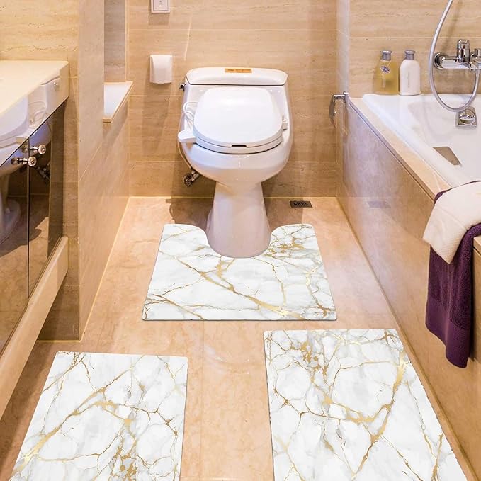 Elegant grey and gold marble bathroom rug set displayed in modern bathroom with beige marble tile floors and white fixtures